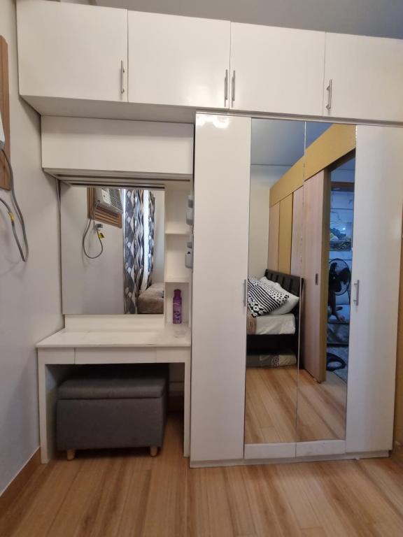 a room with a bunk bed with a mirror at 1BR Condo Rental near Fairview in Manila