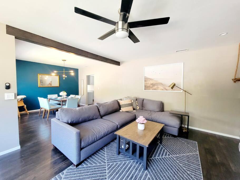a living room with a couch and a ceiling fan at Spacious & Immaculate Haven near Downtown SD in San Diego