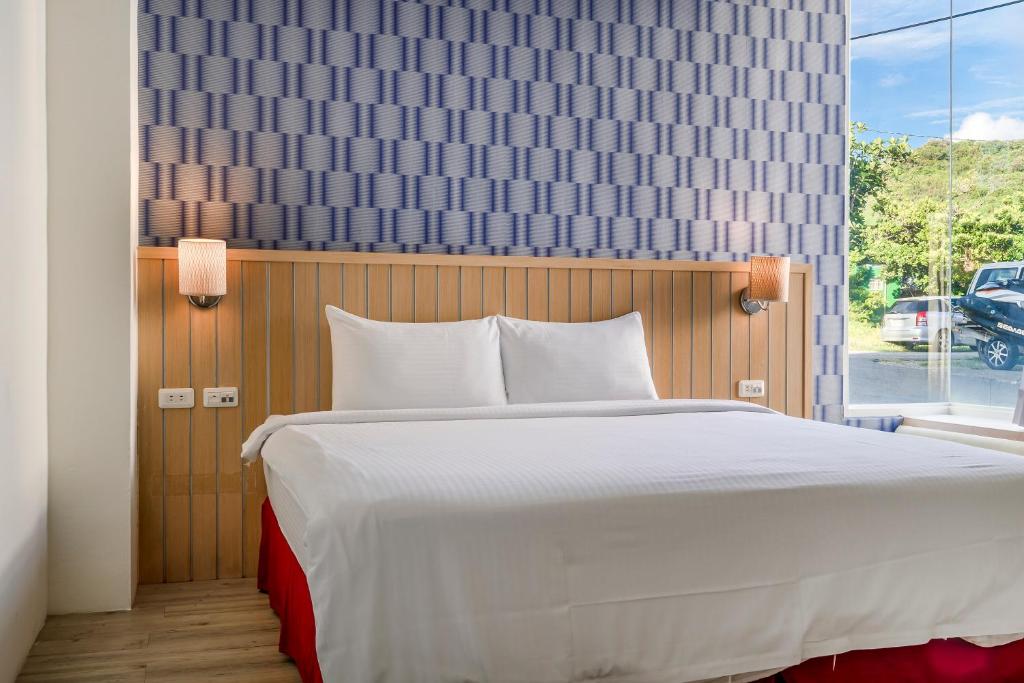 A bed or beds in a room at Green Beauty Homestay