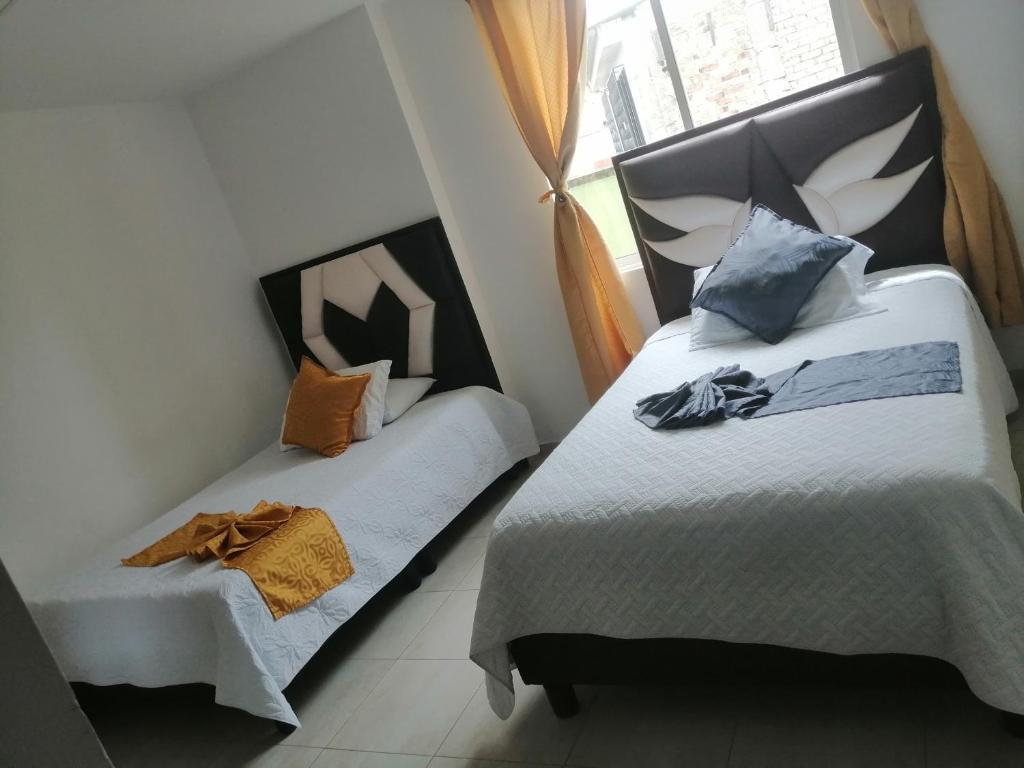 Postel nebo postele na pokoji v ubytování Hotel Linaje Popayán