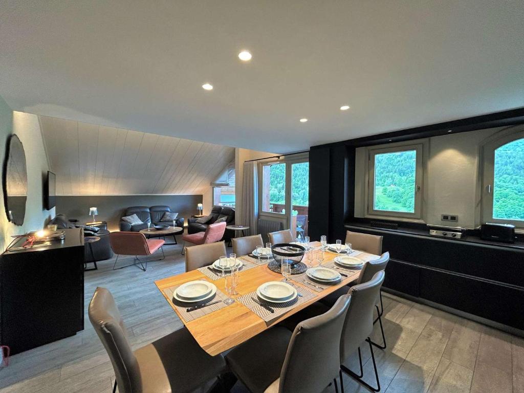 a large dining room with a table and chairs at Appartement 5 pièces avec balcon et garage à Méribel - FR-1-180-624 in Les Allues