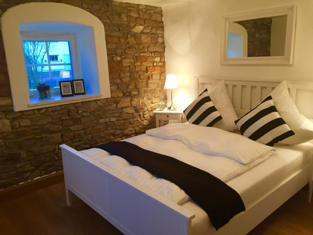 a bedroom with a bed with pillows and a window at Ilmhaus in Pförring