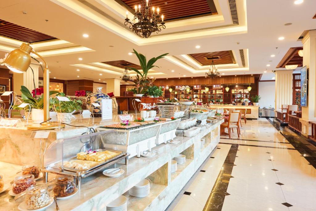 a buffet line in a hotel with food at DLG Hotel Danang in Da Nang