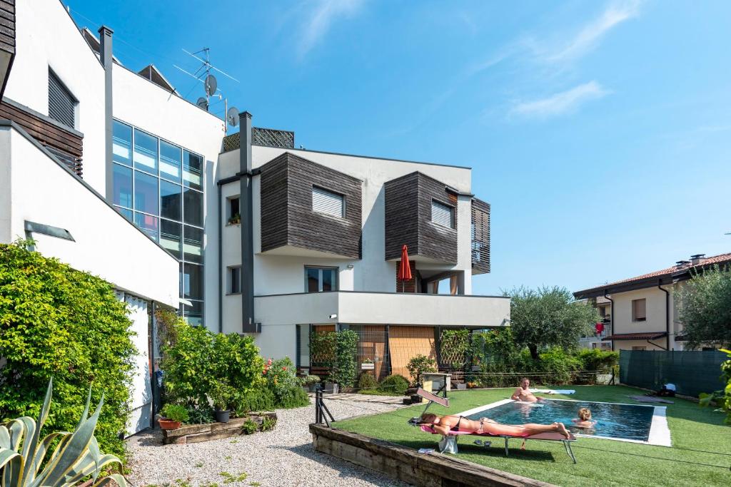 a house with a backyard with a swimming pool at Rosy & Onyx House With Shared Pool in Toscolano Maderno