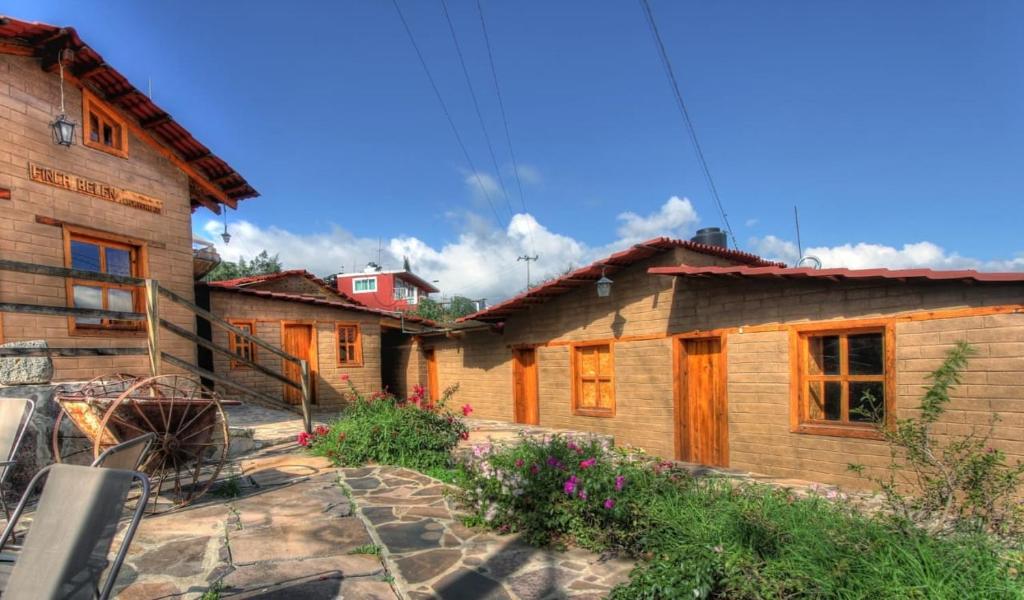 a group of wooden houses in a village at Hotel Finca Belén in Tlaxco de Morelos