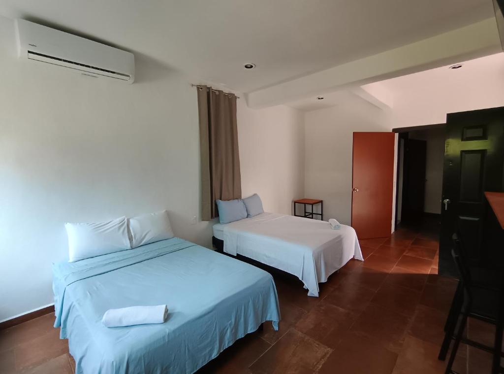 Postel nebo postele na pokoji v ubytování Hotel Miriam Bacalar