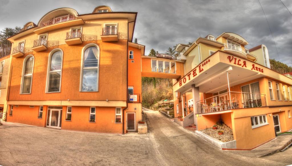 an orange building with a sign on the side of it at Hotel Vila Anna in Martinske Hole