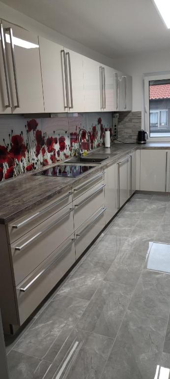 a kitchen with white cabinets and stainless steel appliances at geräumige 4 Zimmer Wohnung mit Balkon in Altendorf