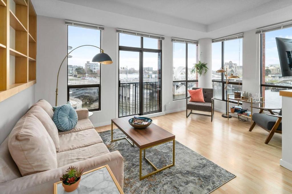 a living room with a couch and a table at Waterfront Stay With Balcony And Bbq in Victoria
