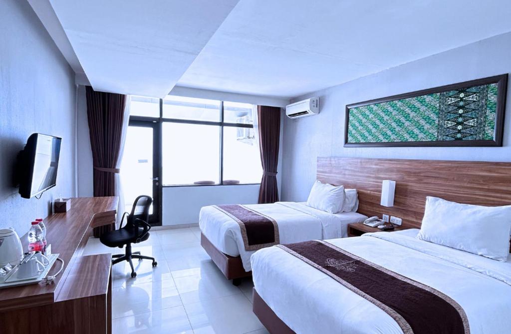 Postel nebo postele na pokoji v ubytování Grand Inna Samudra Beach