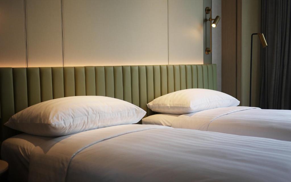 Letto o letti in una camera di Dorsett Kai Tak