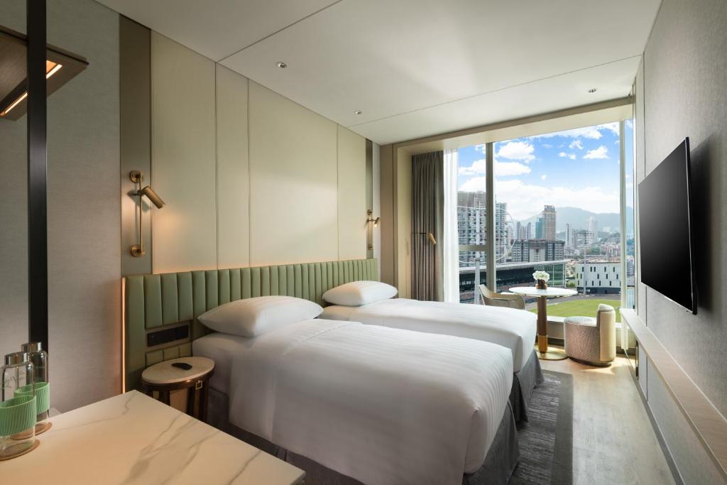 Letto o letti in una camera di Dorsett Kai Tak