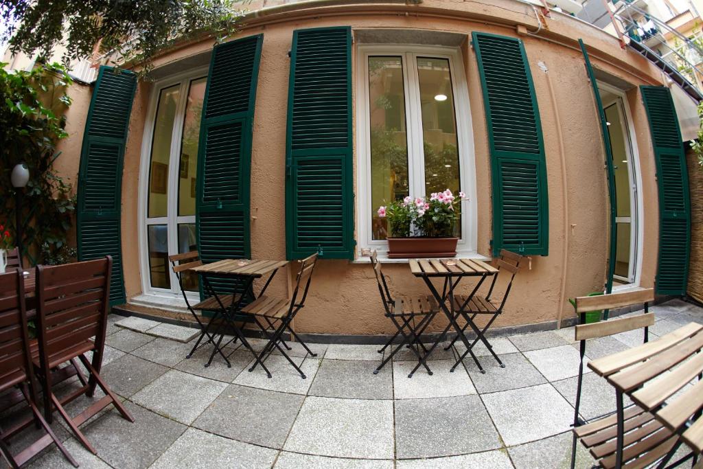 a group of tables and chairs in front of a building at Hotel Lydia in Alassio