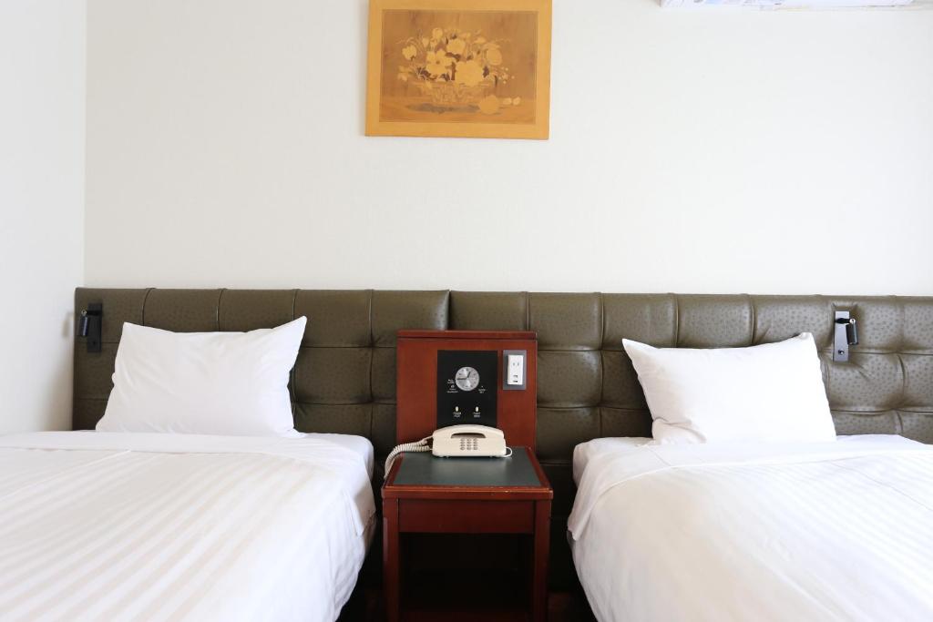 Postel nebo postele na pokoji v ubytování Hotel Castle Inn Suzuka Chuo