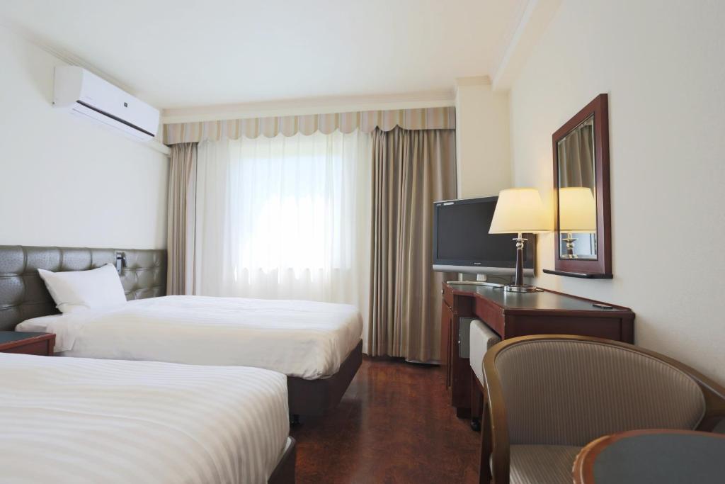 Postel nebo postele na pokoji v ubytování Hotel Castle Inn Suzuka Chuo