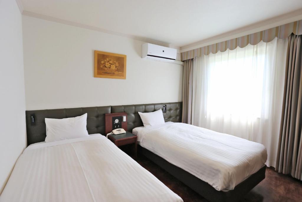 Postel nebo postele na pokoji v ubytování Hotel Castle Inn Suzuka Chuo
