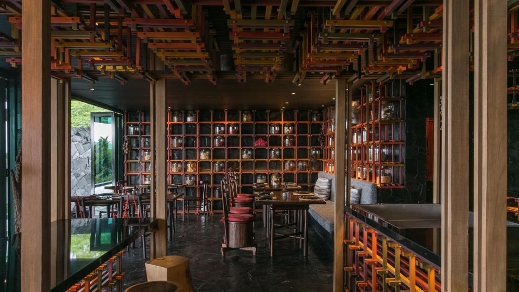 a library with a table and chairs and bookshelves at Barcelo Coconut Island, Phuket in Phuket Town