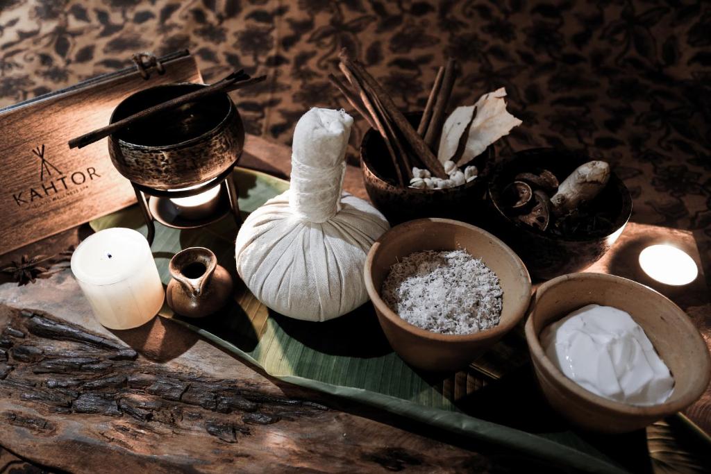 a table topped with different types of ingrediants and candles at Barcelo Coconut Island, Phuket in Phuket Town