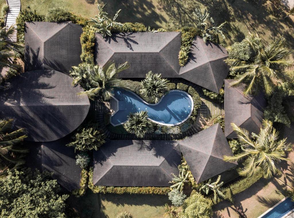 an overhead view of a swimming pool with palm trees at Barcelo Coconut Island, Phuket in Phuket Town