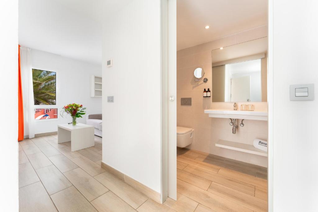 a bathroom with a toilet and a sink at Barceló Corralejo Sands in Corralejo