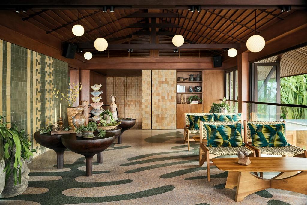 a lobby with couches and chairs and a table at Barcelo Coconut Island, Phuket in Phuket Town