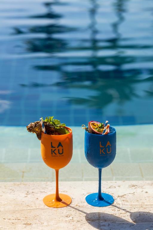 two blue and orange vases sitting next to a swimming pool at Barcelo Coconut Island, Phuket in Phuket Town