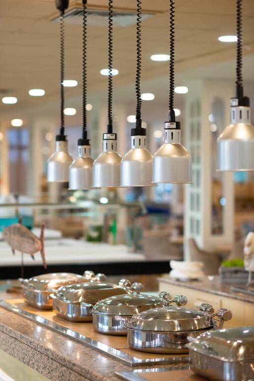 a row of silver pans on a counter in a kitchen at Valentin Son Bou in Son Bou