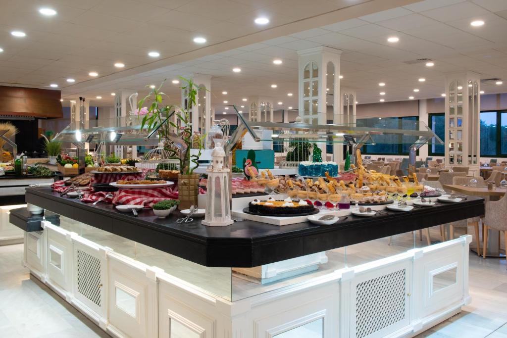 a buffet line with many different types of food at Valentin Son Bou in Son Bou