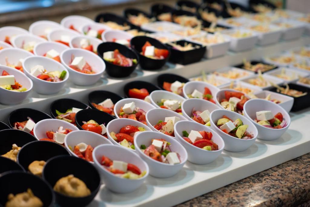 a buffet line of food on a table at Valentin Son Bou in Son Bou