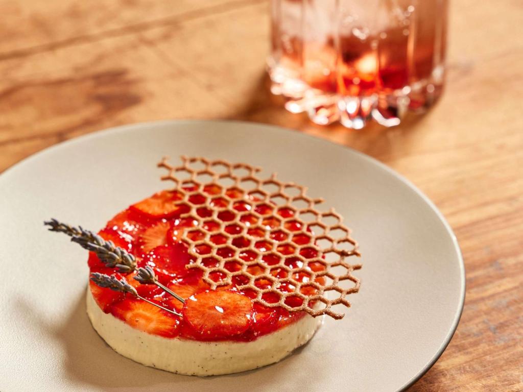 a white plate with a fruit dessert on a table at Sofitel Golfe d'Ajaccio Thalassa Sea & Spa in Ajaccio