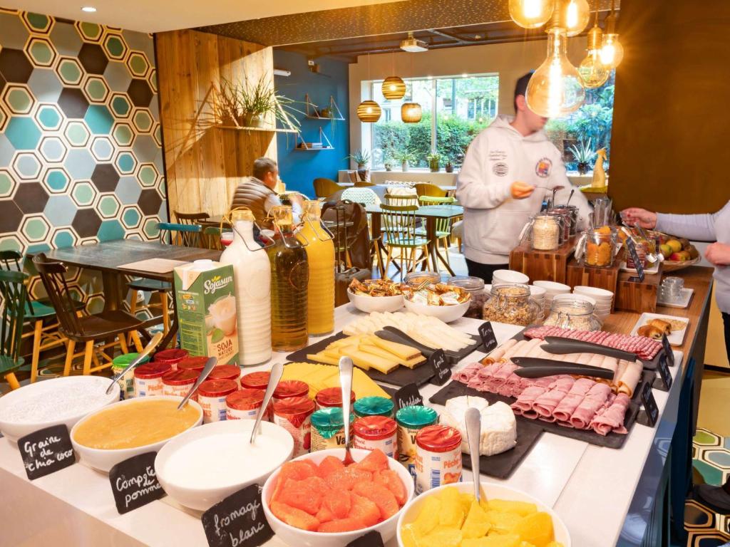 a buffet of food on a table in a restaurant at ibis Styles Paris 16 Boulogne in Paris