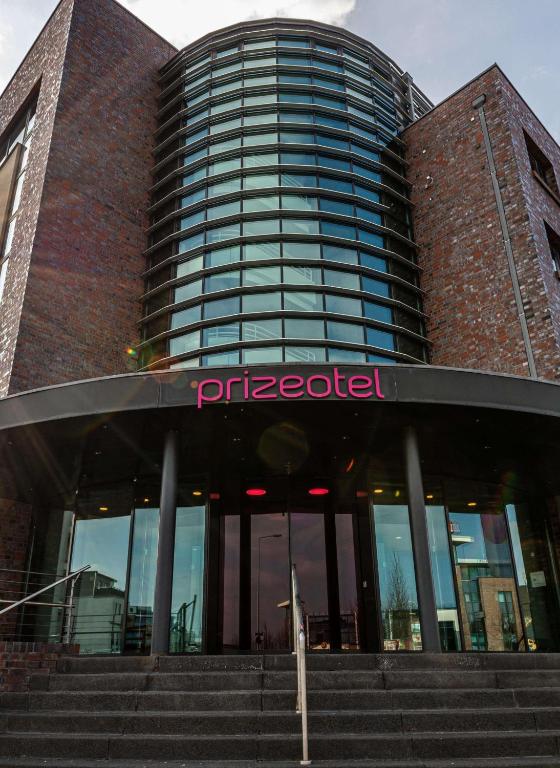 a building with a sign on the front of it at Prize by Radisson, Rostock City in Rostock