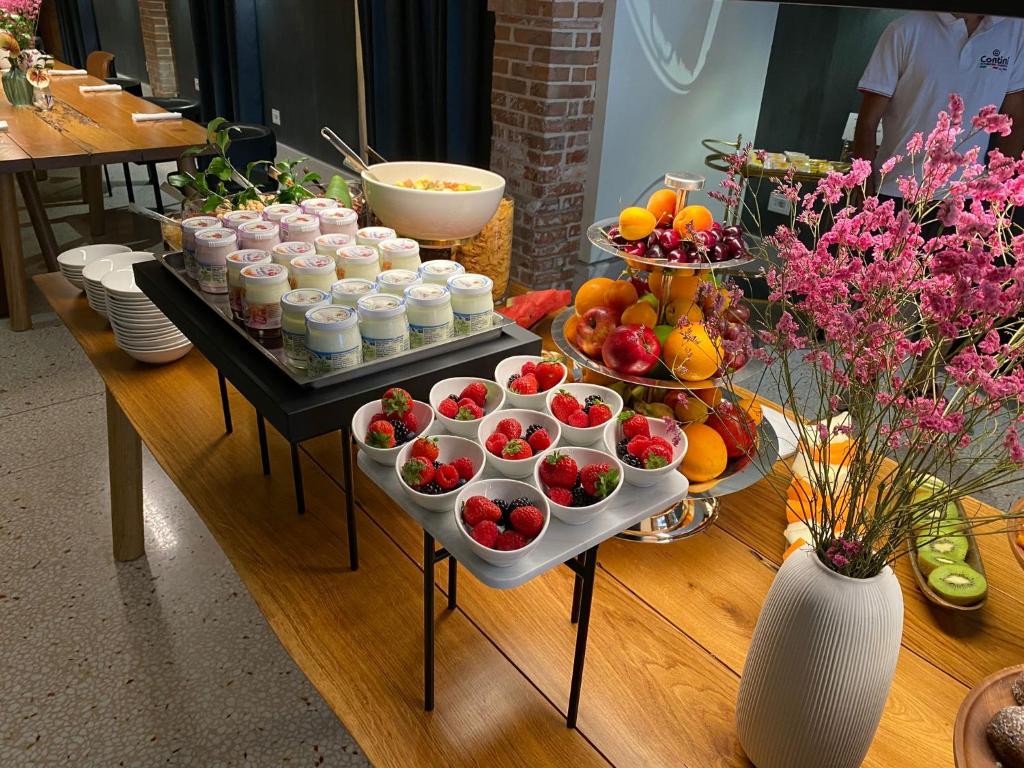 a table topped with appetizers and bowls of fruit at Ca' Bonfadini Historic Experience in Venice