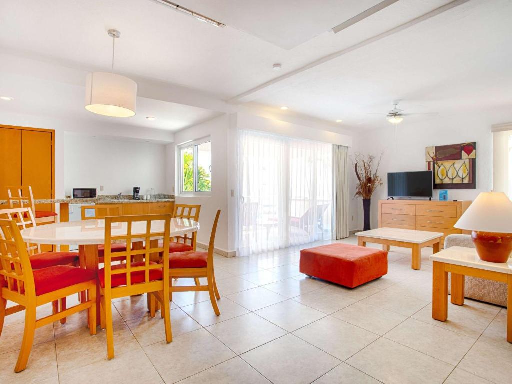 a kitchen and dining room with a table and chairs at Marival Emotions Resort & Suites Riviera Nayarit by Mercure in Nuevo Vallarta