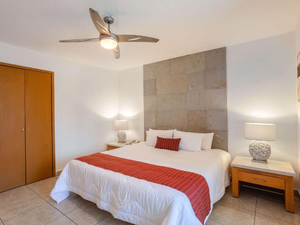 a bedroom with a bed and a ceiling fan at Marival Emotions Resort & Suites Riviera Nayarit by Mercure in Nuevo Vallarta