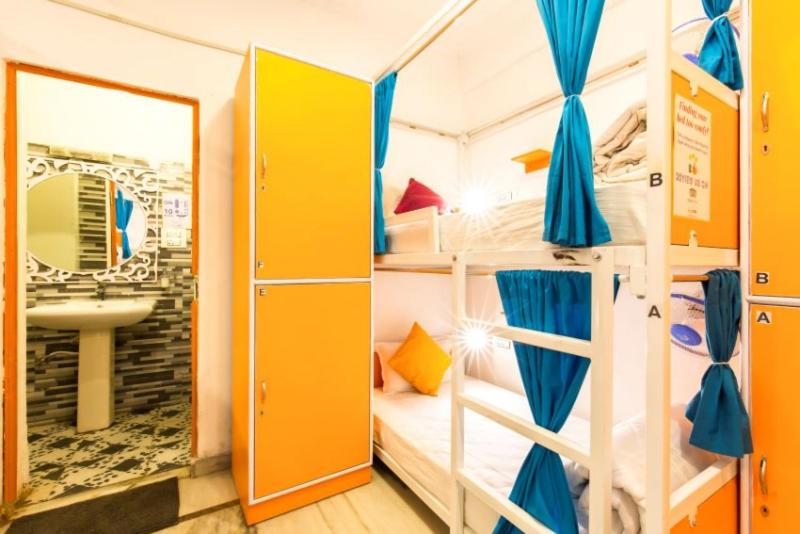 a room with two bunk beds and a mirror at ZoukStayz in Rishīkesh