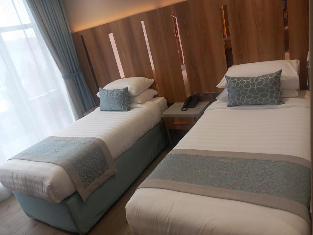 Postel nebo postele na pokoji v ubytování فندق نسمات مكةNasamat Makkah Hotel