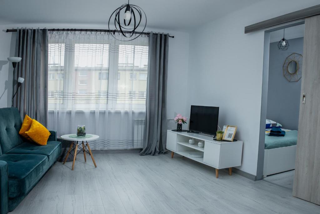 Televízia a/alebo spoločenská miestnosť v ubytovaní Lovely place-apartament Oświęcim
