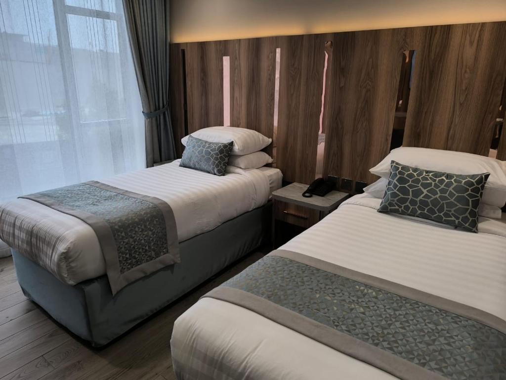 Postel nebo postele na pokoji v ubytování فندق نسمات مكةNasamat Makkah Hotel