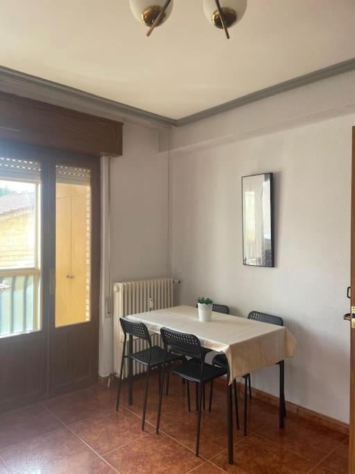 a dining room with a table and chairs and a window at VUT Casa Albar in Soria