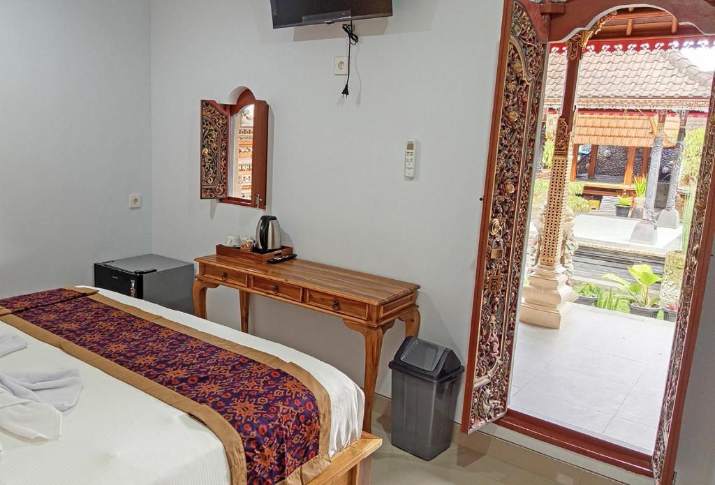 Postel nebo postele na pokoji v ubytování Mahaguna Ubud