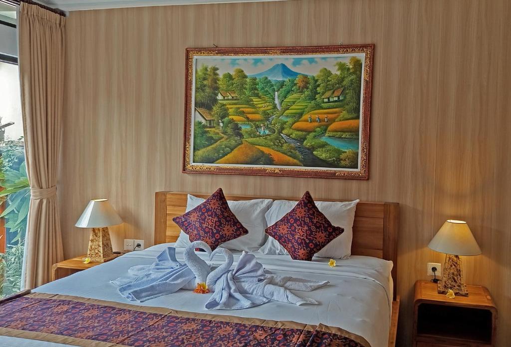 Postel nebo postele na pokoji v ubytování Mahaguna Ubud