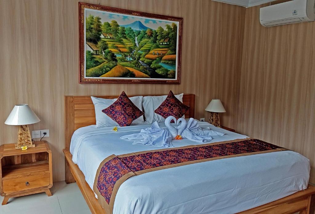 Postel nebo postele na pokoji v ubytování Mahaguna Ubud