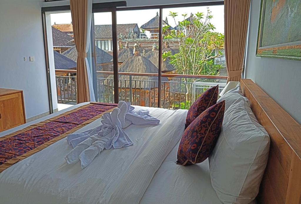 Postel nebo postele na pokoji v ubytování Mahaguna Ubud