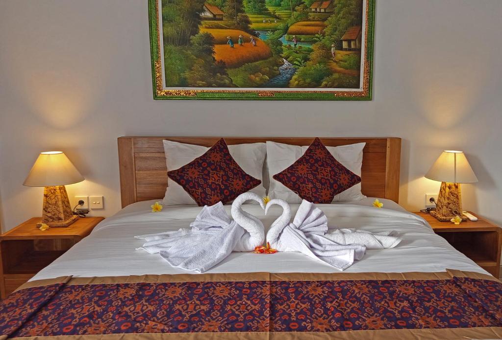 Postel nebo postele na pokoji v ubytování Mahaguna Ubud