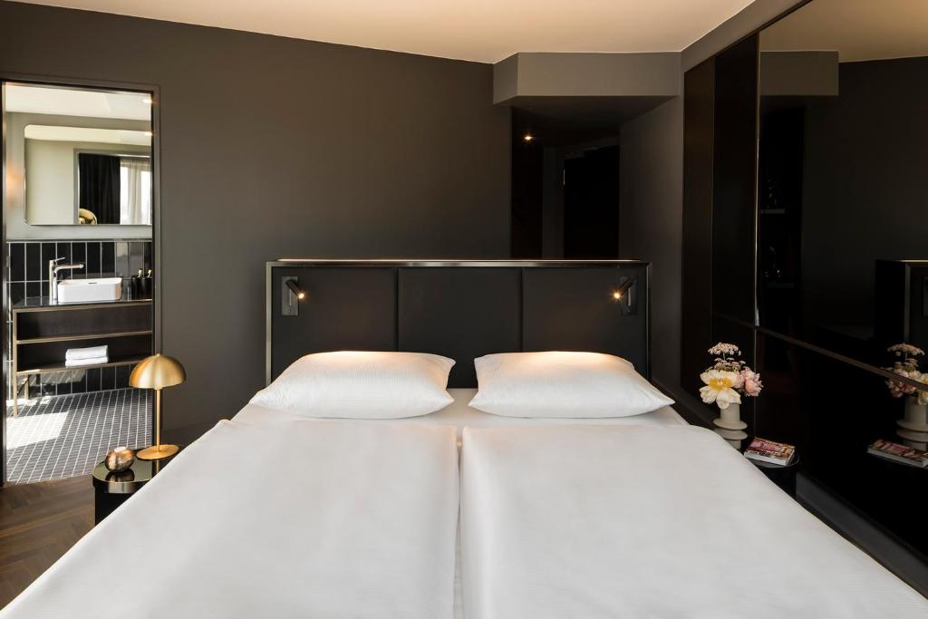 Postel nebo postele na pokoji v ubytování Hotel ROMY by AMANO