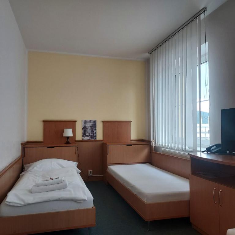Postel nebo postele na pokoji v ubytování Garni G Hotel Žilina