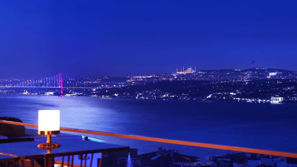 a view of a bridge over the water at night at CVK Park Bosphorus Hotel Istanbul in Istanbul