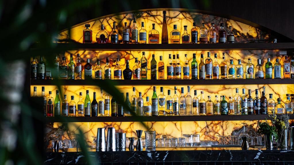 a wall filled with lots of bottles of alcohol at CVK Park Bosphorus Hotel Istanbul in Istanbul