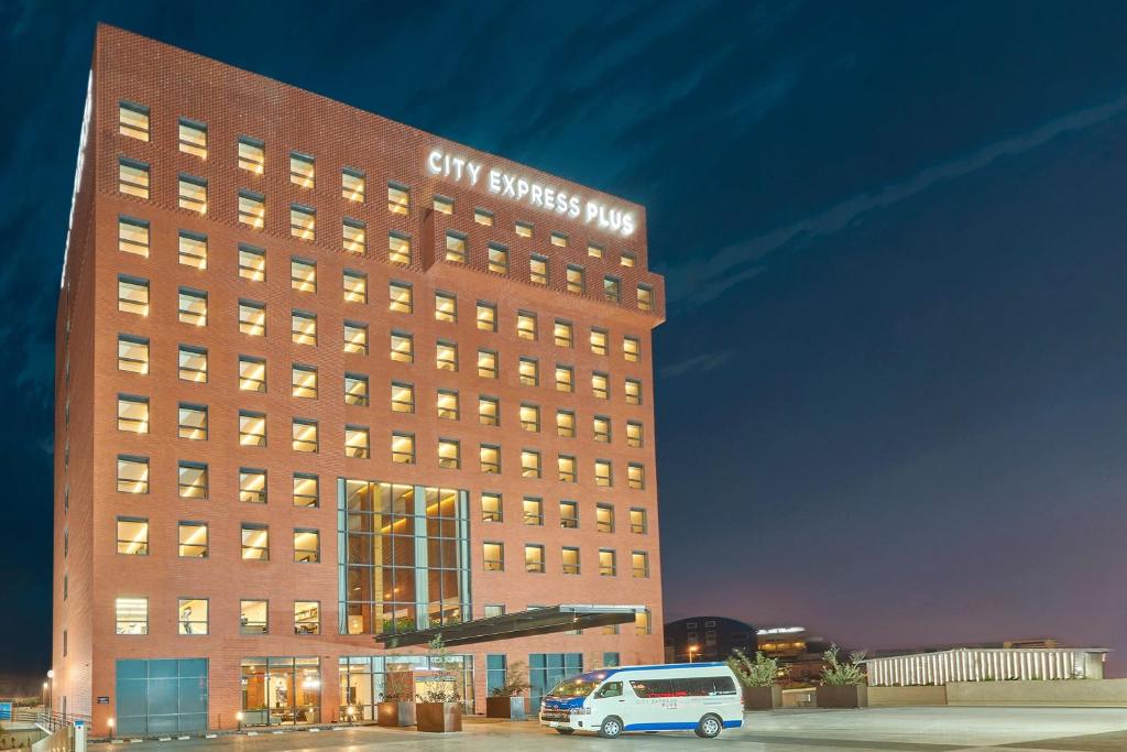 a building with a van parked in front of it at City Express Plus by Marriott Tijuana in Tijuana